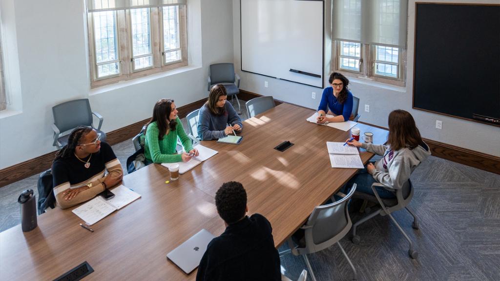 Students gathered around seminar table