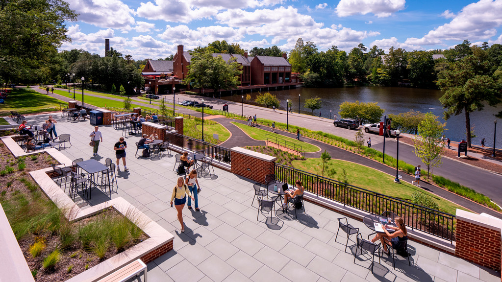 View of library patio overlooking lake and commons building