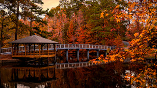 Gazebo on a lake island surrounded by fall foliage