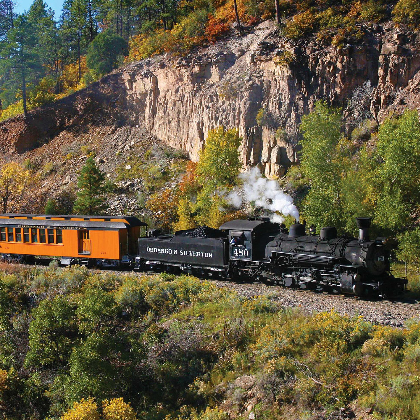 Steam train traveling on a mountain railroad
