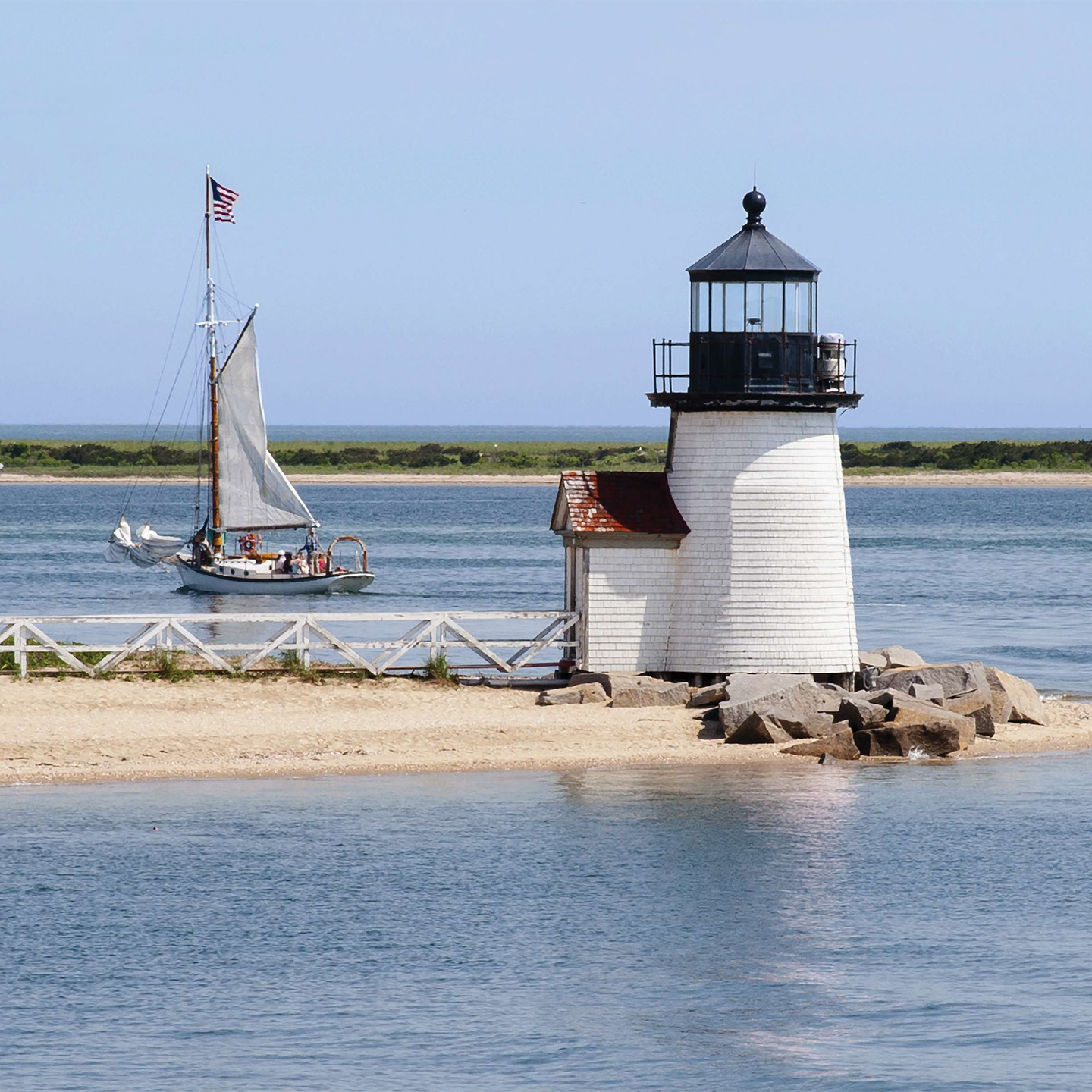 Lighthouse and sailboat on the water