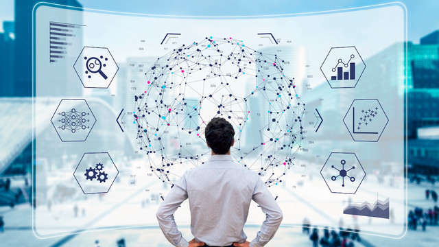 Person standing in front of an illustration of a giant screen with internetworked icons