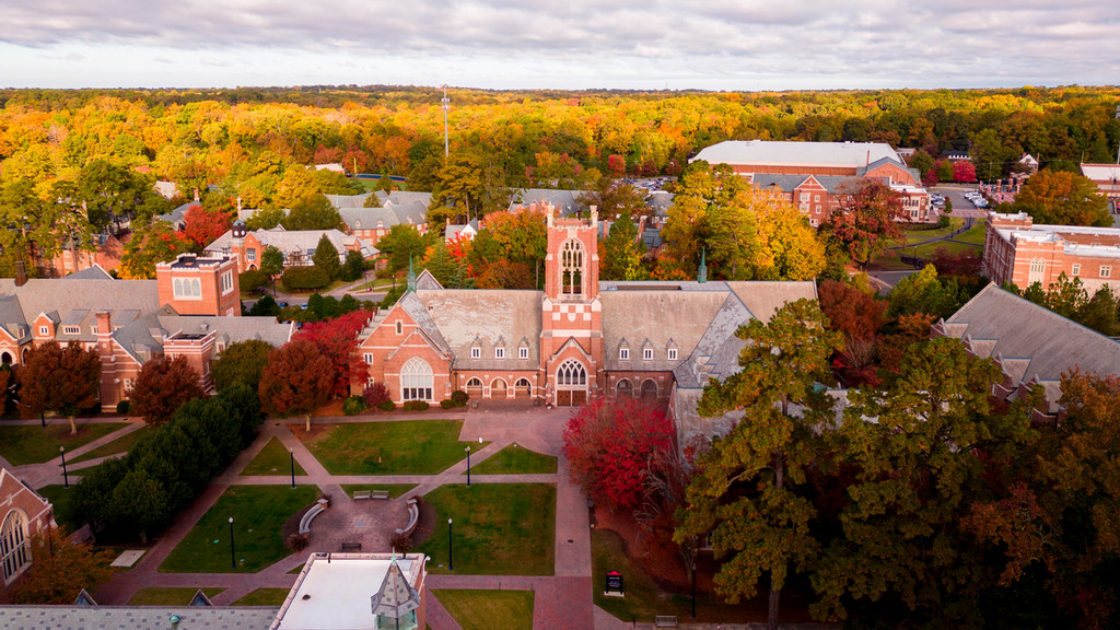 Aerial view of campus showing fall foliage in the background and Jepson Hall and Stern Plaza in the foreground