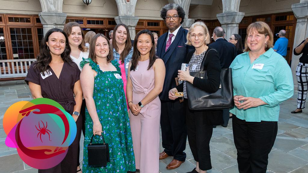Group of students posing outdoors during a cocktail reception