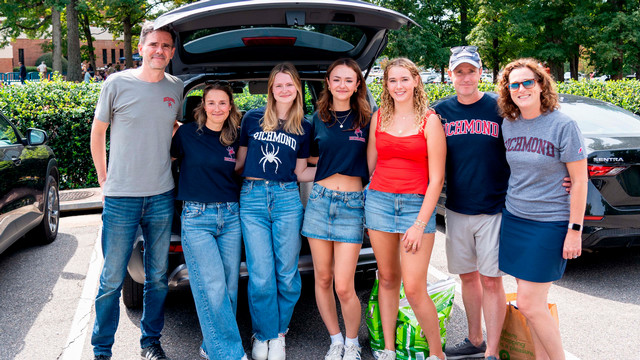 Family posing for photo at tailgate