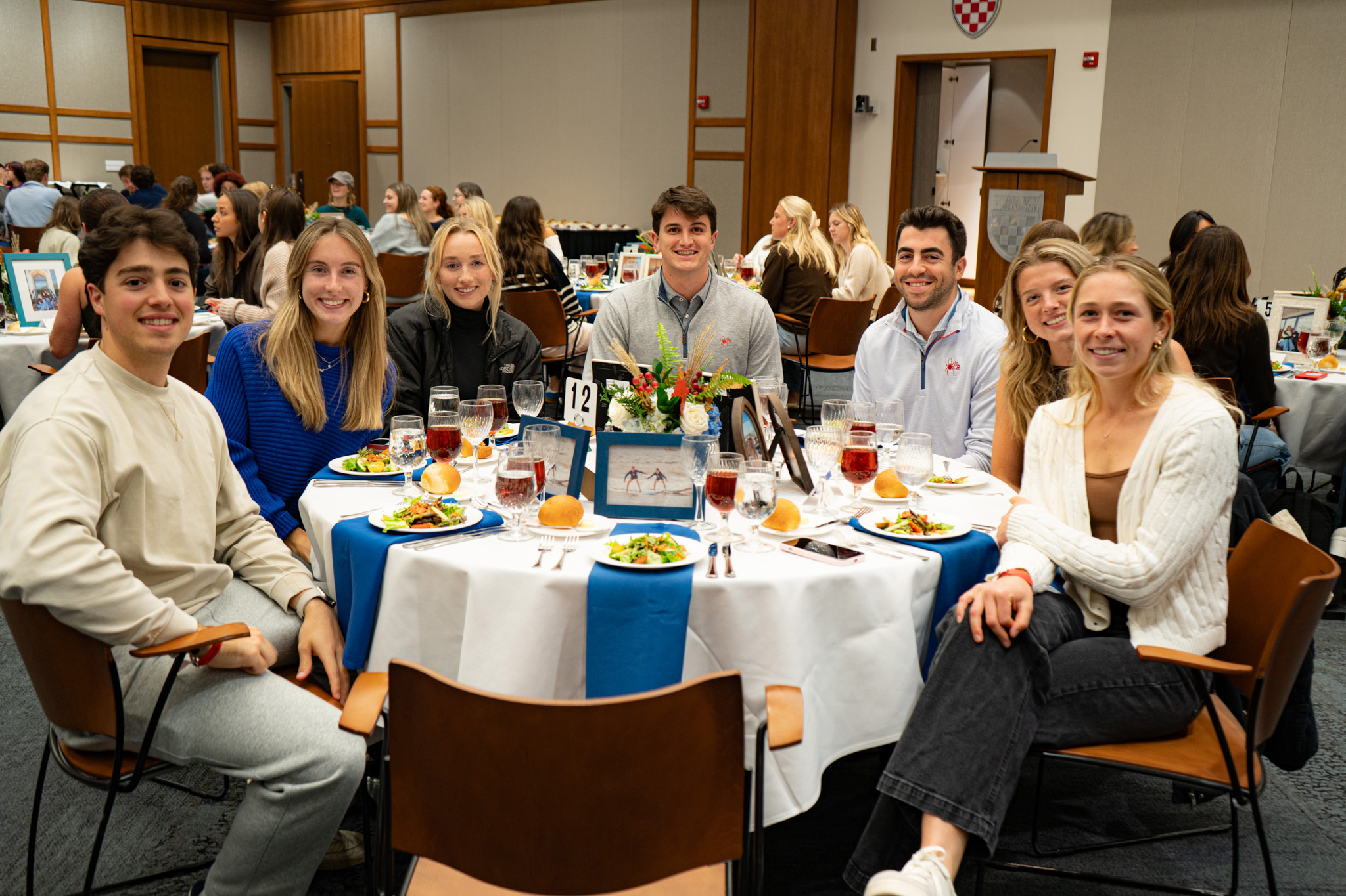 Students gathered around a table at dinner