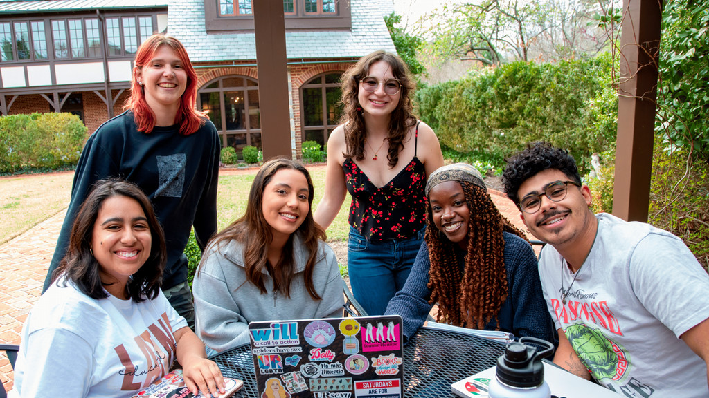 Students gathered together outside on campus.