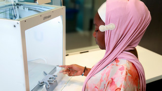 Technology consultant looking at 3D printer