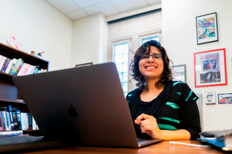 Dr. Patricia Herrera at her computer