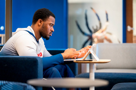 A student working on his tablet in Spider Hall