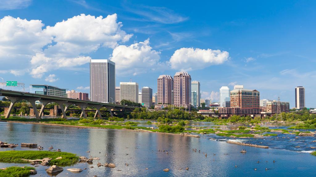 Richmond city skyline on a suny day with the James River in the foreground