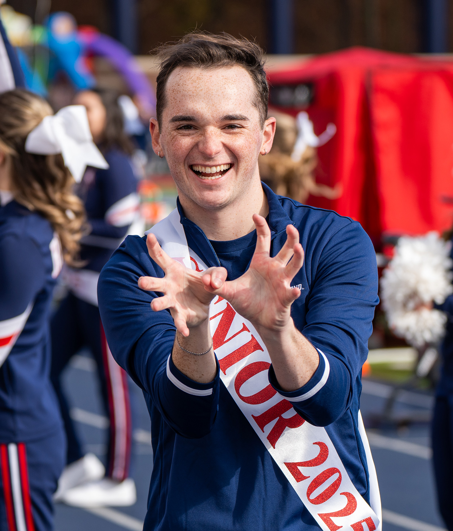 Cheerleader making spider symbol with hands
