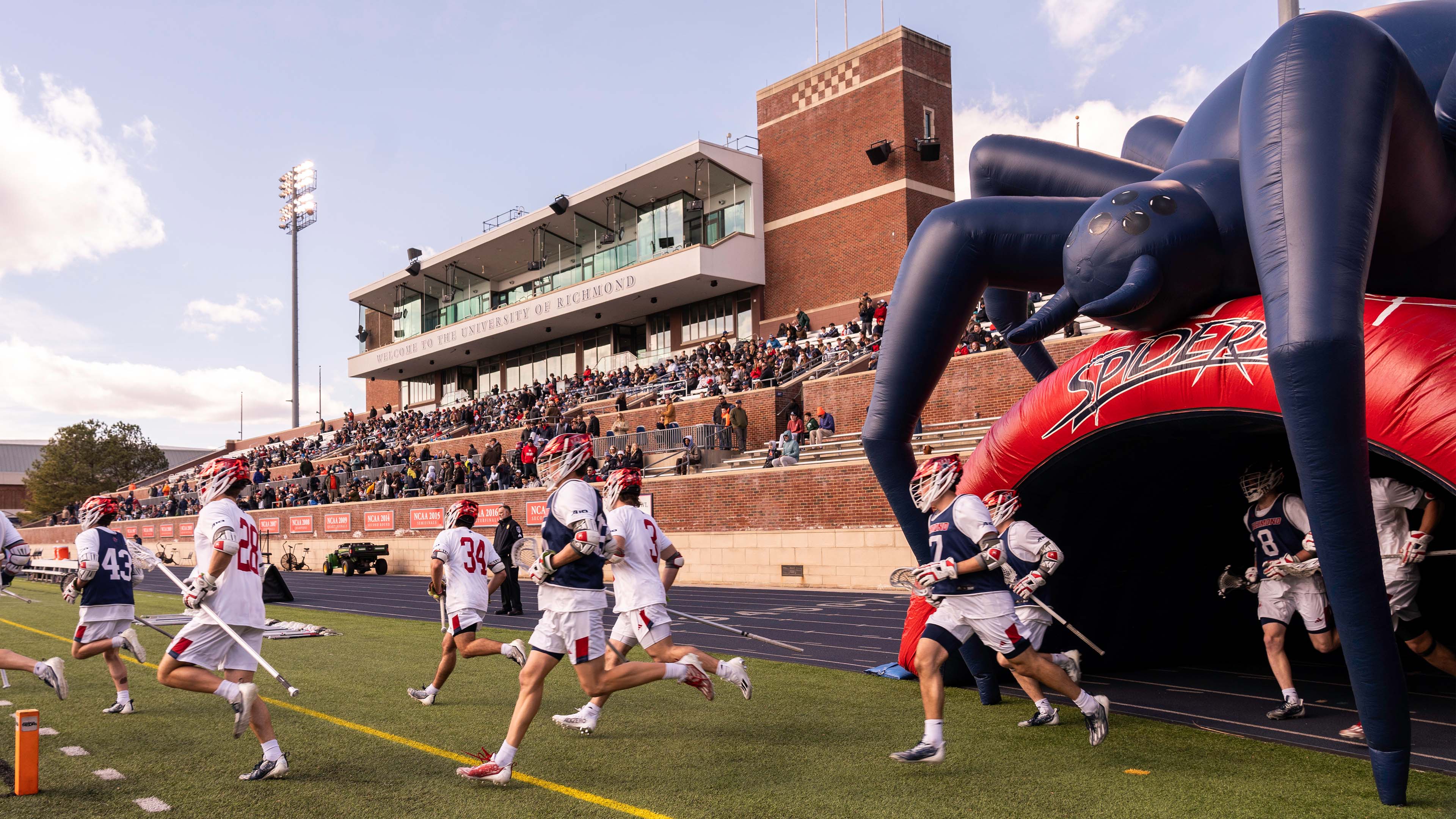Lacrosse team entering the field at Robins Stadium