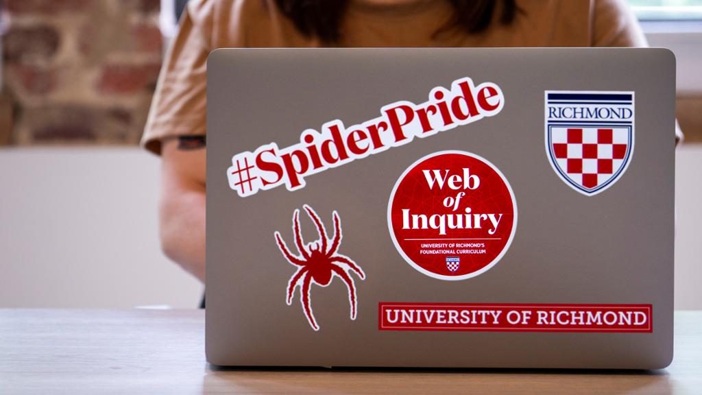 laptop with spider pride stickers 