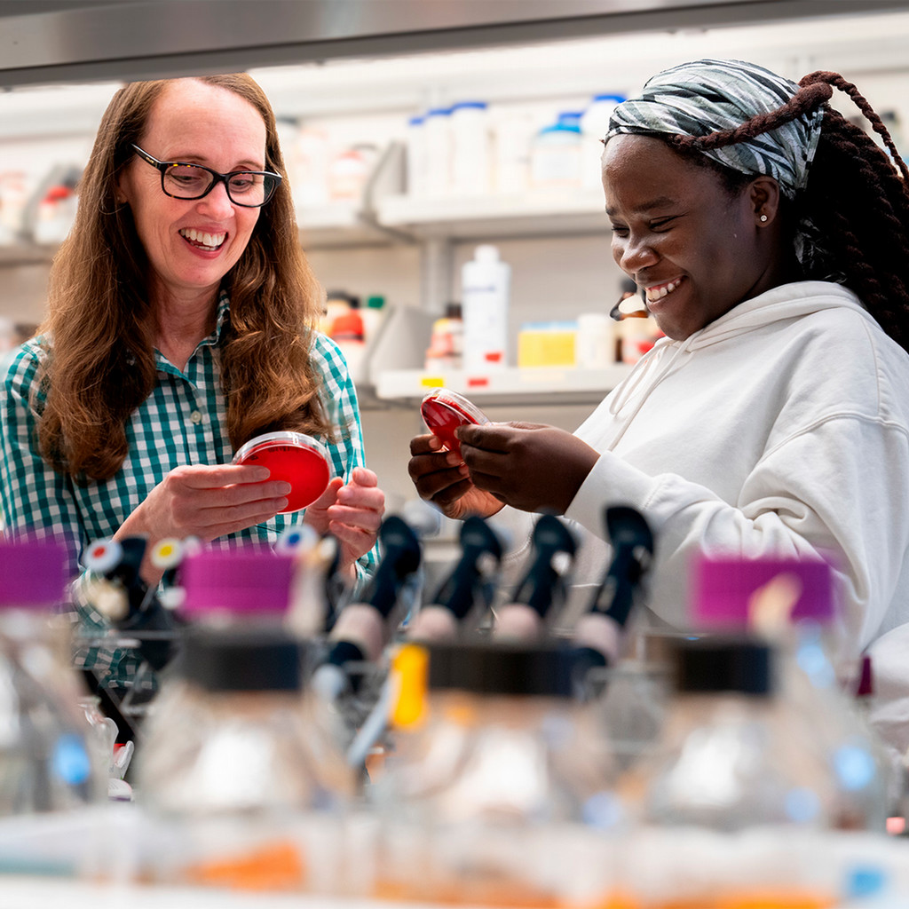 A student and professor in the lab