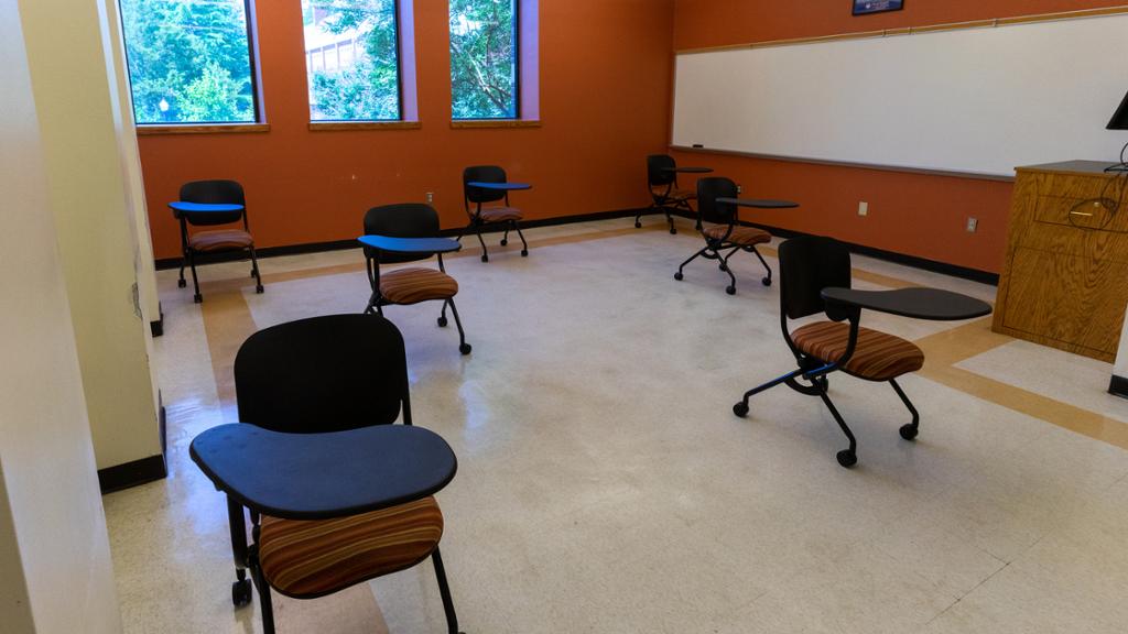 Interior of a classroom where the desks and chairs have been spaced out to provide at least six feet separation.