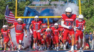 Football team coming onto the field
